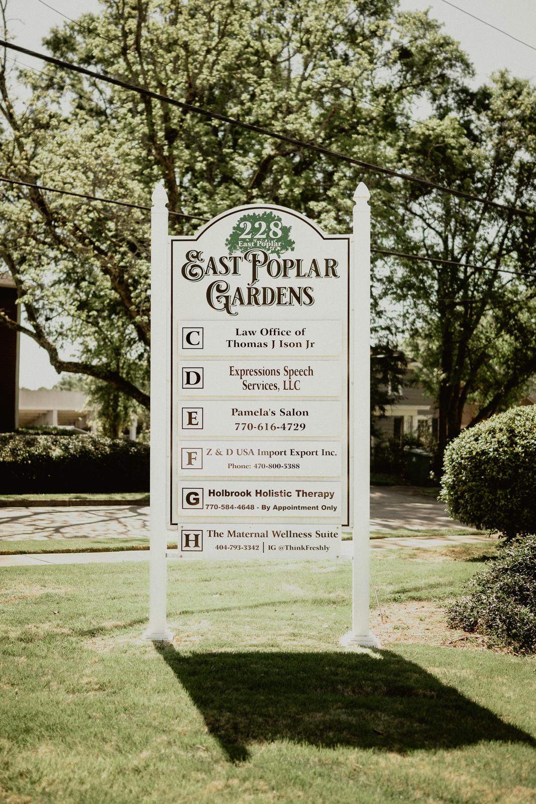 The East Poplar Gardens sign listing Suite G, Holbrook Holistic Therapy