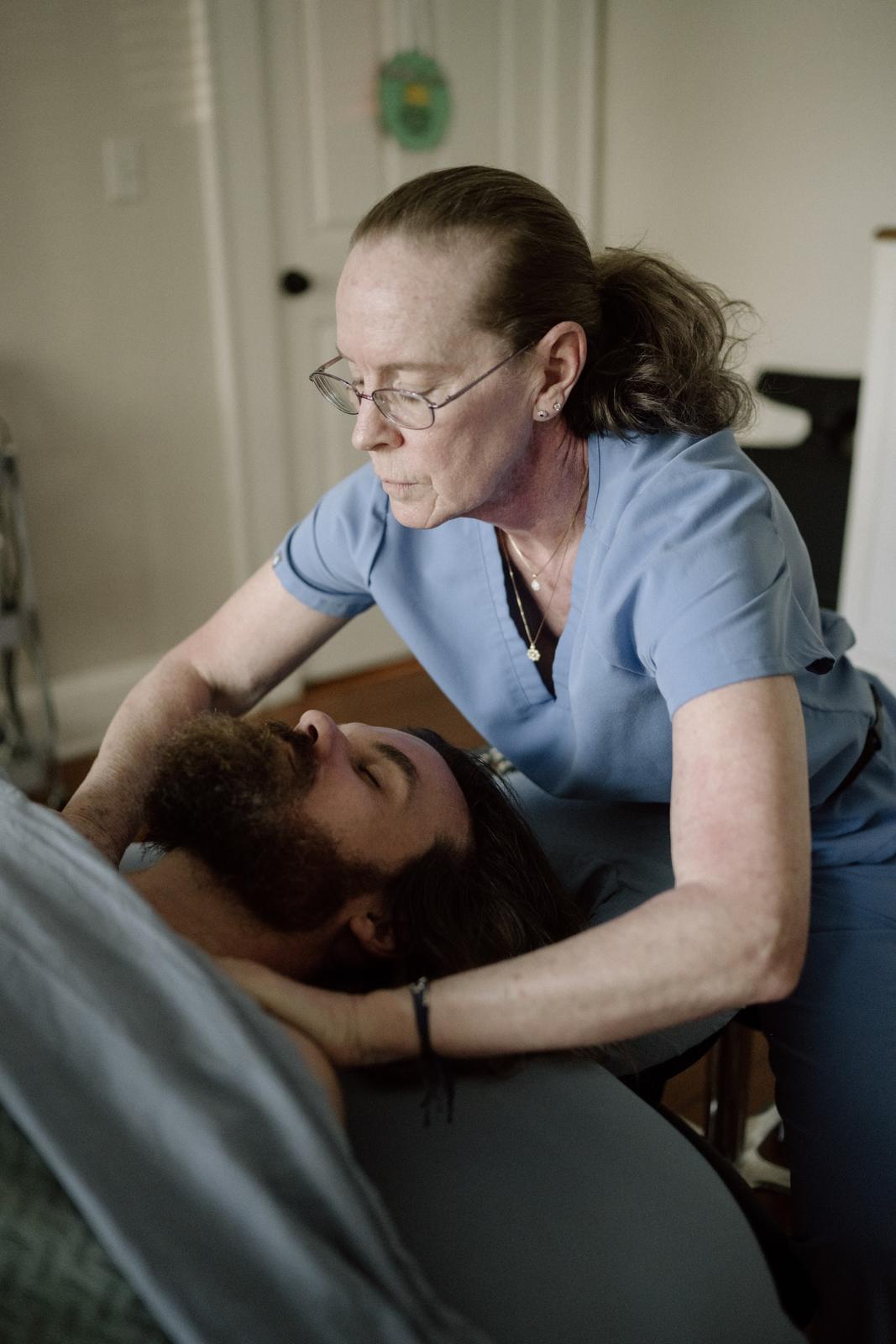 A therapist working gently on a client's neck